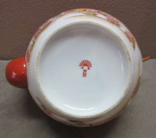 A gorgeous traditional oriental tea pot. Stunning in a kitchen cabinet!