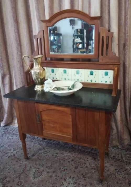 A wonderful vintage solid Oak single door wash stand with a black marble top on castors - stunning!!