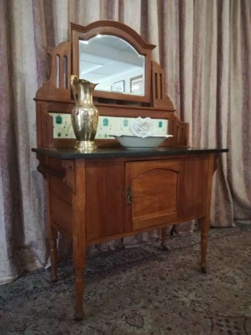 A wonderful vintage solid Oak single door wash stand with a black marble top on castors - stunning!!