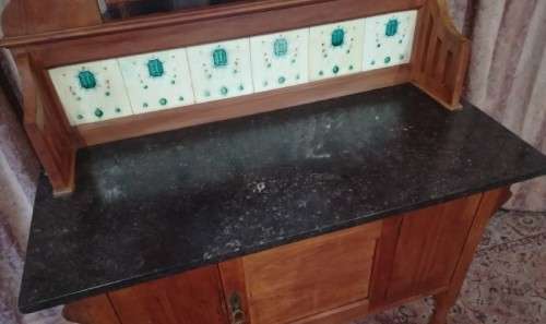 A wonderful vintage solid Oak single door wash stand with a black marble top on castors - stunning!!
