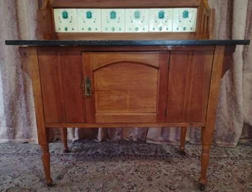 A wonderful vintage solid Oak single door wash stand with a black marble top on castors - stunning!!
