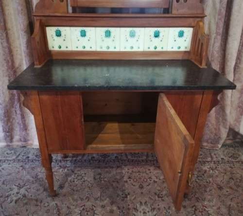 A wonderful vintage solid Oak single door wash stand with a black marble top on castors - stunning!!