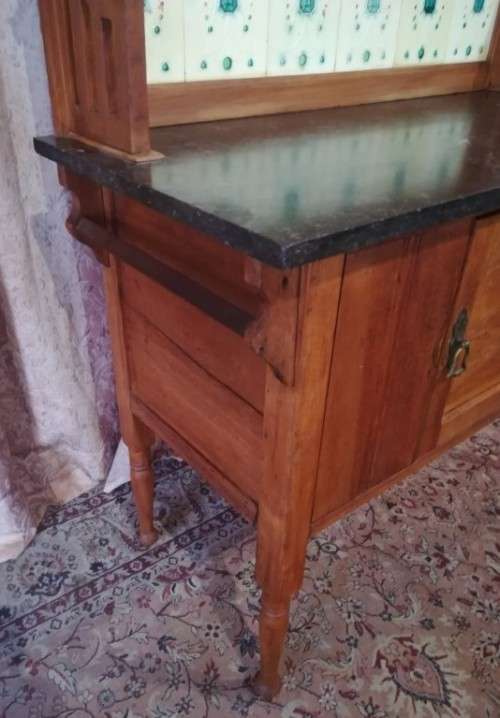 A wonderful vintage solid Oak single door wash stand with a black marble top on castors - stunning!!