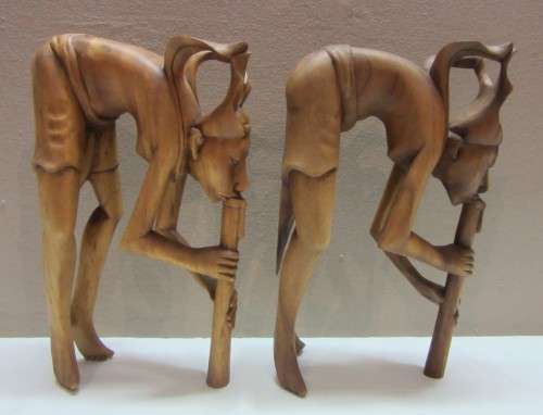A lovely pair of Balinese carvings of men playing a flute. Great on display.