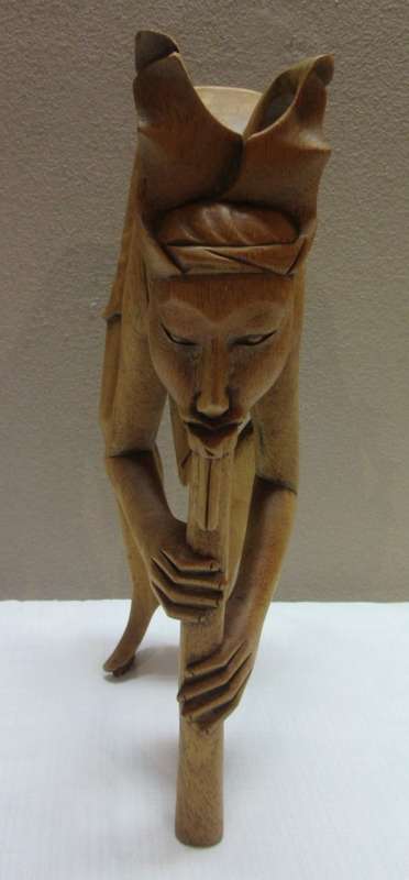 A lovely pair of Balinese carvings of men playing a flute. Great on display.