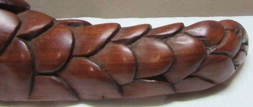 A lovely wooden hand carving of a Pangolin great on display or added to a collection.