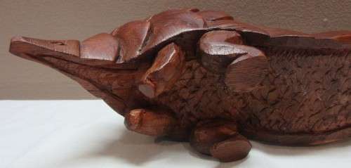 A lovely wooden hand carving of a Pangolin great on display or added to a collection.