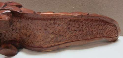 A lovely wooden hand carving of a Pangolin great on display or added to a collection.