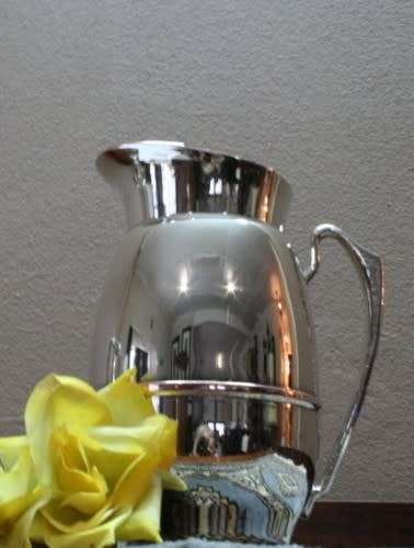 A gorgeous silver plated water jug/ pitcher with an ice lip in good usable condition.