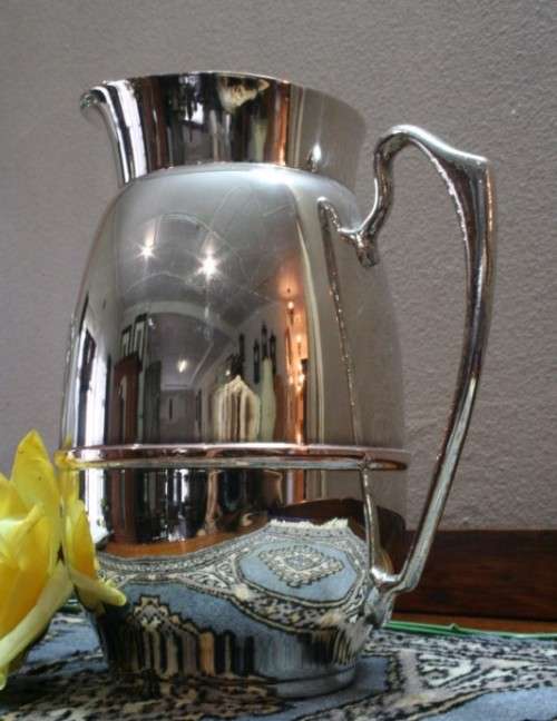A gorgeous silver plated water jug/ pitcher with an ice lip in good usable condition.