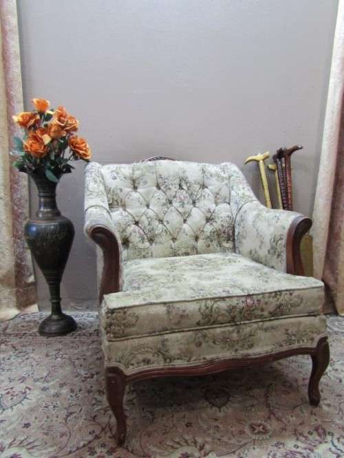 A gorgeous vintage Victorian styled arm chair w deep button, carved detailing & floral upholstery.