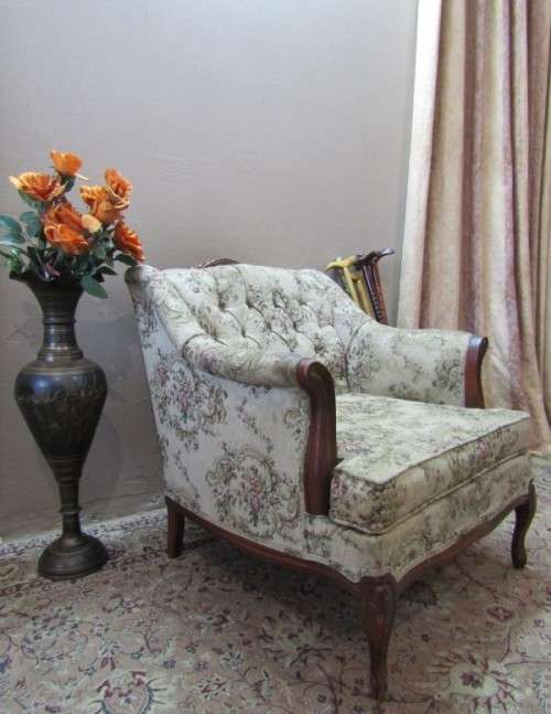 A gorgeous vintage Victorian styled arm chair w deep button, carved detailing & floral upholstery.
