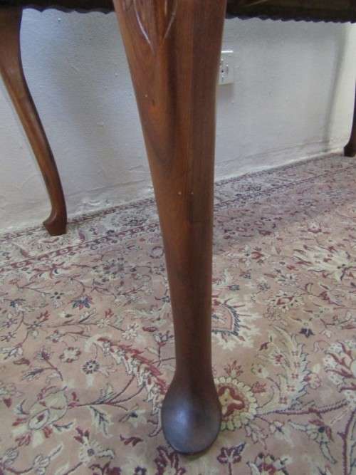 An exquisite solid Teak, scalloped edge, Queen Anne footed 6-seater dining table.