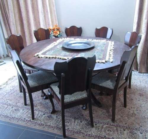 A wonderful solid Imbuia dining suite with a large round table and 8 x upholstered chairs