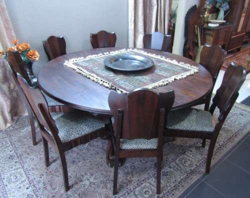 A wonderful solid Imbuia dining suite with a large round table and 8 x upholstered chairs