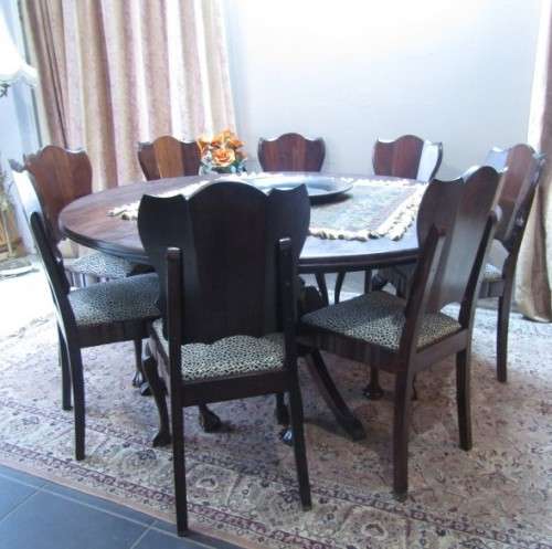 A wonderful solid Imbuia dining suite with a large round table and 8 x upholstered chairs