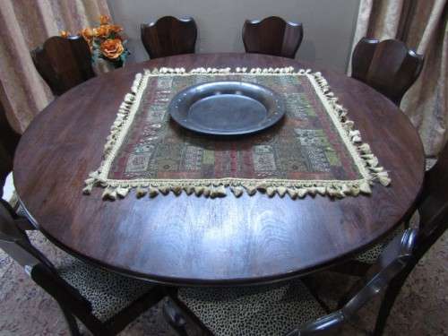 A wonderful solid Imbuia dining suite with a large round table and 8 x upholstered chairs