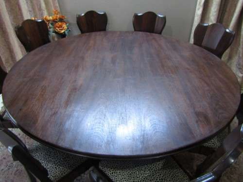 A wonderful solid Imbuia dining suite with a large round table and 8 x upholstered chairs