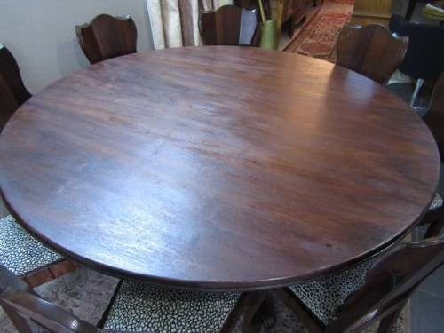 A wonderful solid Imbuia dining suite with a large round table and 8 x upholstered chairs
