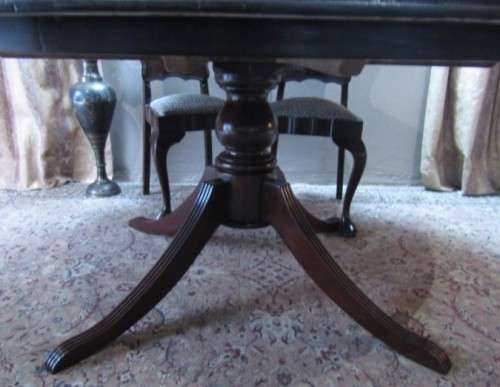 A wonderful solid Imbuia dining suite with a large round table and 8 x upholstered chairs