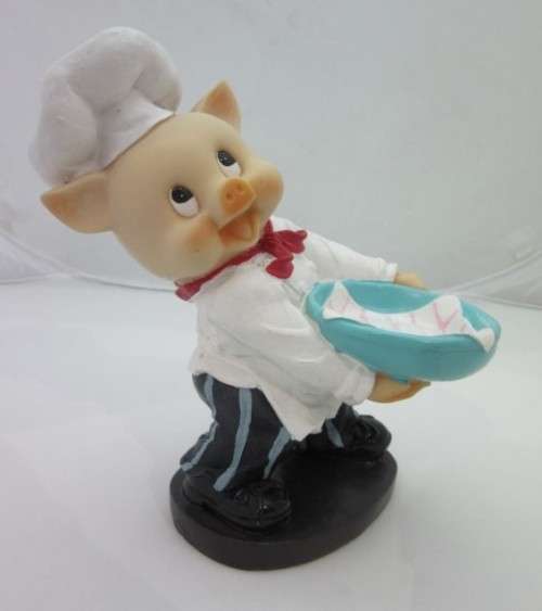 A magnificent hand crafted resin mold, hand painted pig chef statue. Amazing on display.