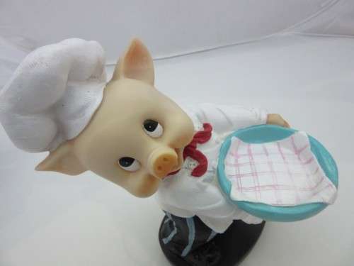 A magnificent hand crafted resin mold, hand painted pig chef statue. Amazing on display.