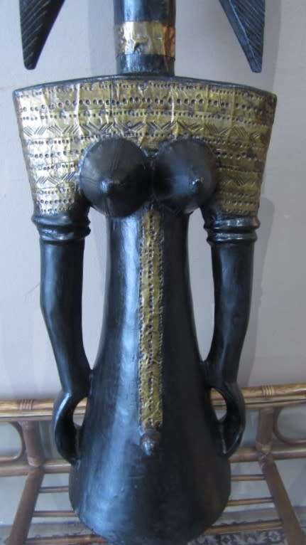 A fantastic large traditional hand carved double sided African mask with brass detailing!