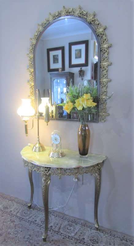 An exquisite moulded solid brass mirror & marble half moon table with ornate detailing. Wow!!!