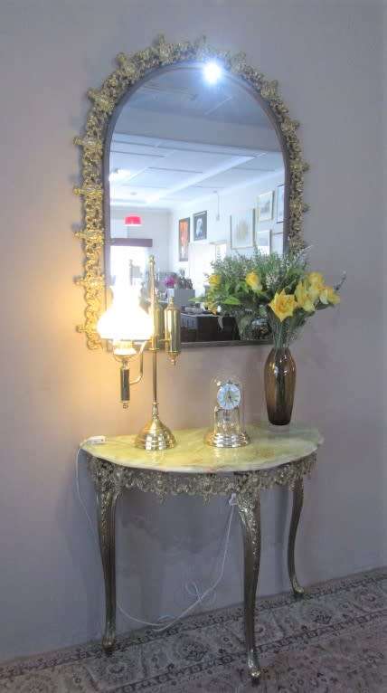 An exquisite moulded solid brass mirror & marble half moon table with ornate detailing. Wow!!!