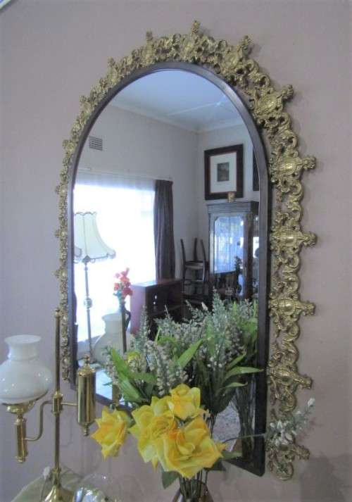 An exquisite moulded solid brass mirror & marble half moon table with ornate detailing. Wow!!!