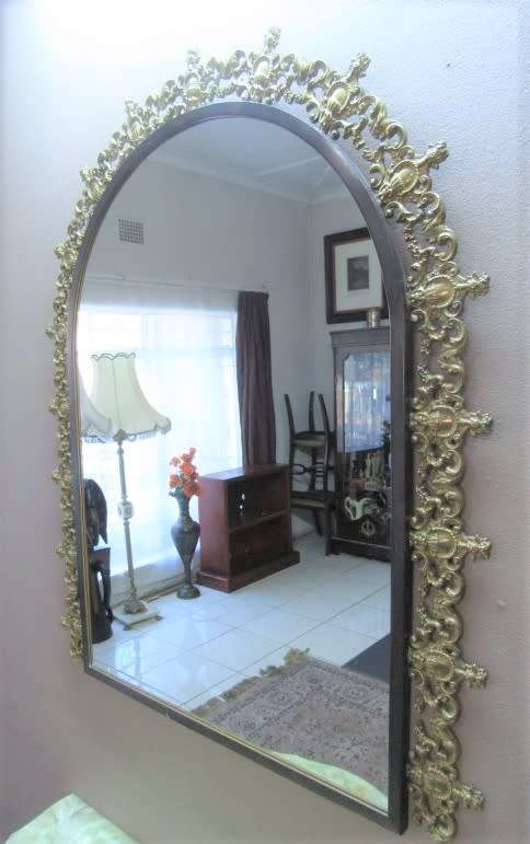 An exquisite moulded solid brass mirror & marble half moon table with ornate detailing. Wow!!!