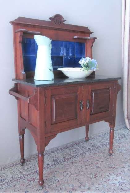 A wonderful vintage solid Oak double door wash stand with a black marble top on castors - stunning!!