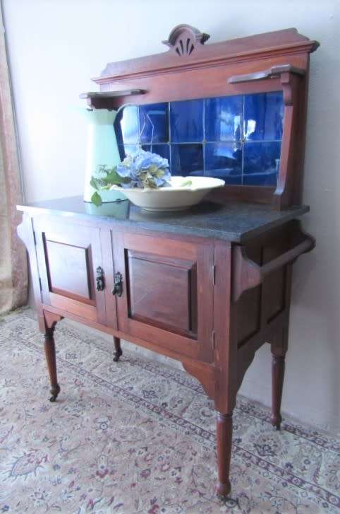 A wonderful vintage solid Oak double door wash stand with a black marble top on castors - stunning!!