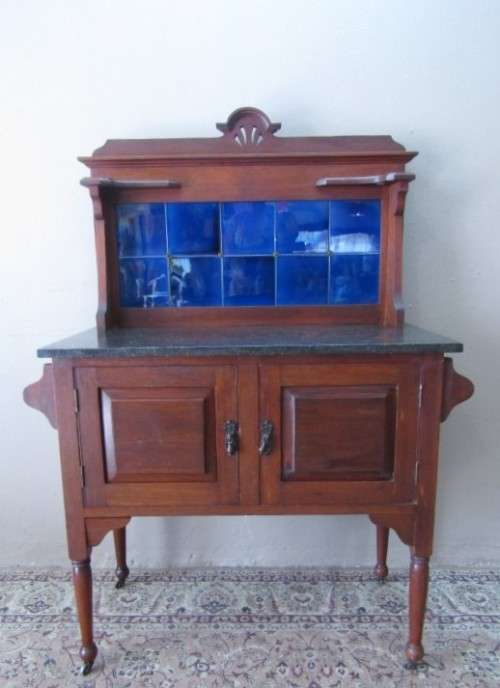 A wonderful vintage solid Oak double door wash stand with a black marble top on castors - stunning!!