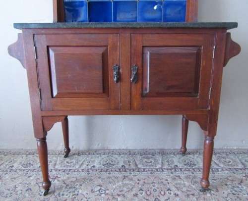 A wonderful vintage solid Oak double door wash stand with a black marble top on castors - stunning!!