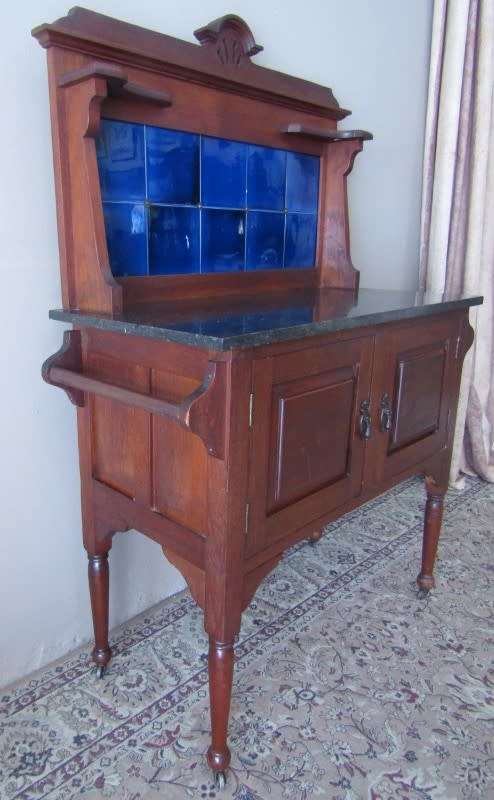 A wonderful vintage solid Oak double door wash stand with a black marble top on castors - stunning!!