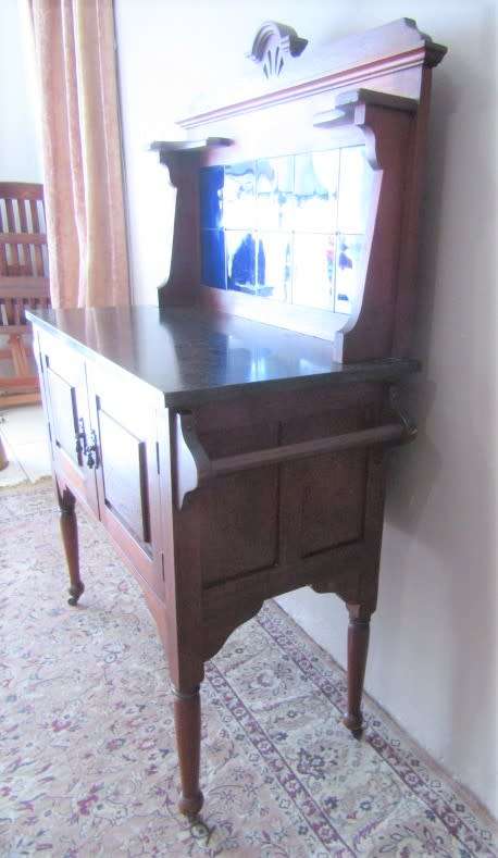A wonderful vintage solid Oak double door wash stand with a black marble top on castors - stunning!!