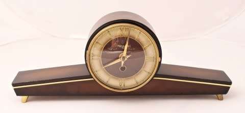 A beautiful wooden Mercedes mantel clock decorate with brass trimmings, working cold. Lifespace Sale
