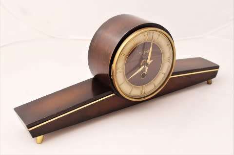 A beautiful wooden Mercedes mantel clock decorate with brass trimmings, working cold. Lifespace Sale