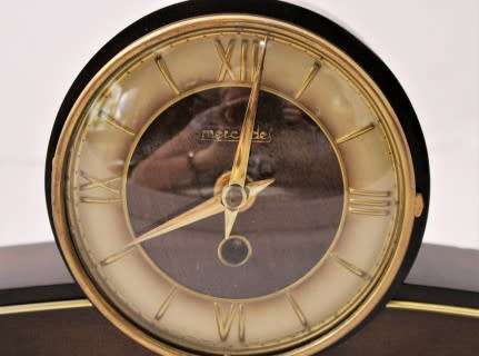 A beautiful wooden Mercedes mantel clock decorate with brass trimmings, working cold. Lifespace Sale