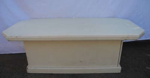 A coffee table for informal living spaces, needs some work or cover.