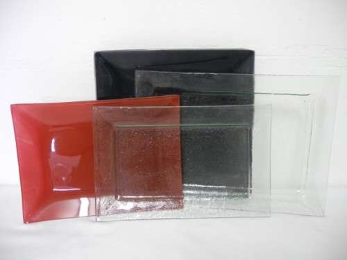 Four modern glass serving plates incl a red and black plate. Lifespace Sale