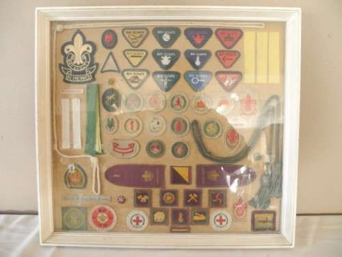 A framed behind glass assortment of Scout badges-Lifespace Sale