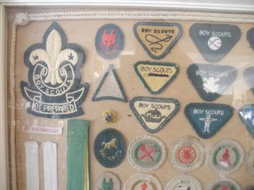 A framed behind glass assortment of Scout badges-Lifespace Sale