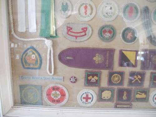 A framed behind glass assortment of Scout badges-Lifespace Sale