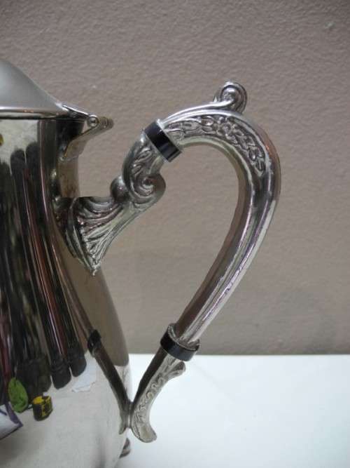 A wonderful ornate vintage silver plated teapot w/ a finial lid in good condition.