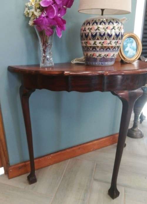 A  vintage solid Imbuia scalloped edge ball & claw half moon display/ occ table.Xmas sale