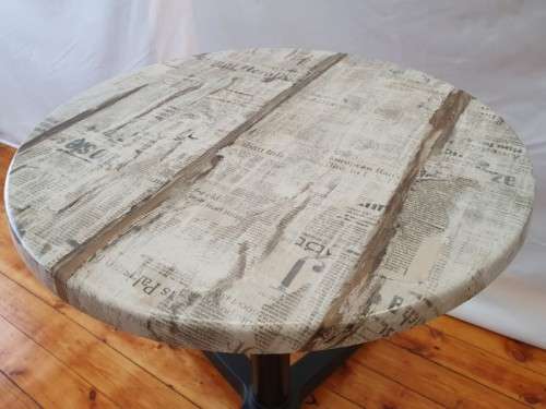 A lovely cafe style round table with newspaper print for indoor or outdoor use.-Xmas sale
