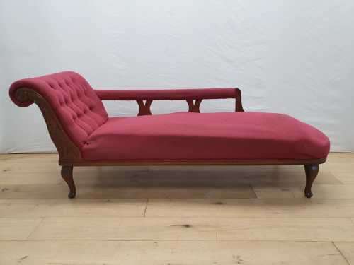 An Edwardian rail-back upholstered Chaise Lounge