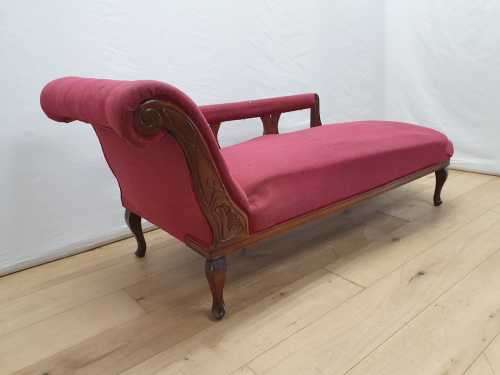 An Edwardian rail-back upholstered Chaise Lounge